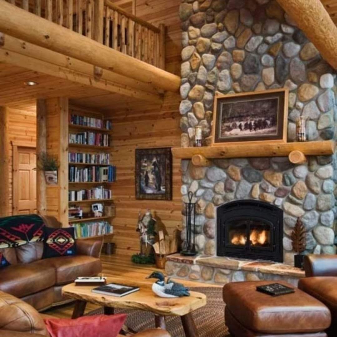 Stylish fireplace made of fieldstone halves. Atmospheric interior. 